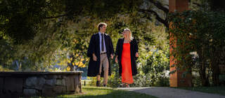 St John's College students walking in the sunshine in their academic gowns