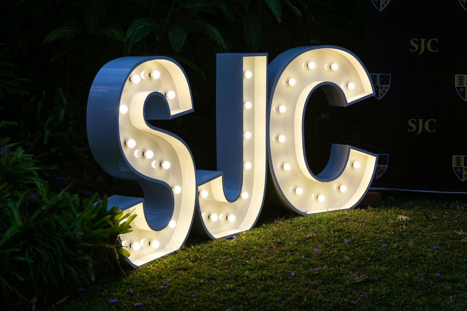 SJC in lights on the lawn at night