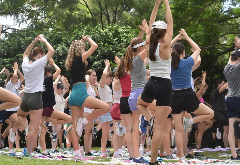 Students doing yoga outside