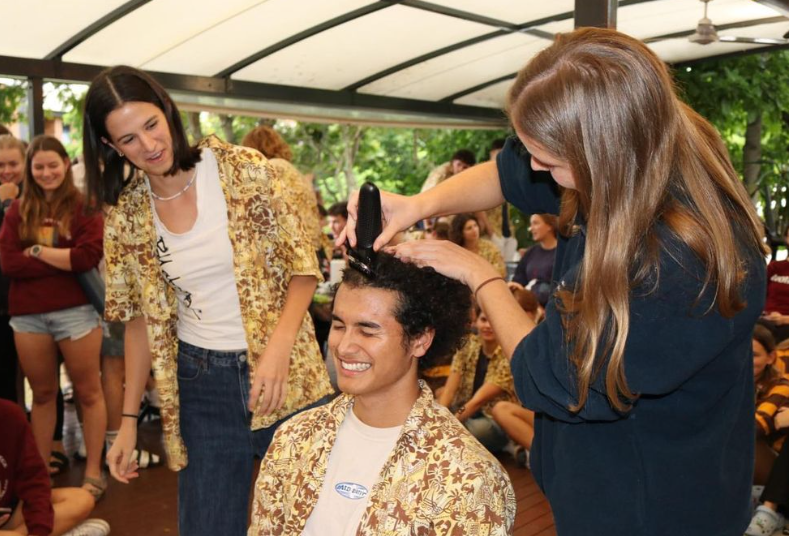 Students raising money for charity by getting heads shaved